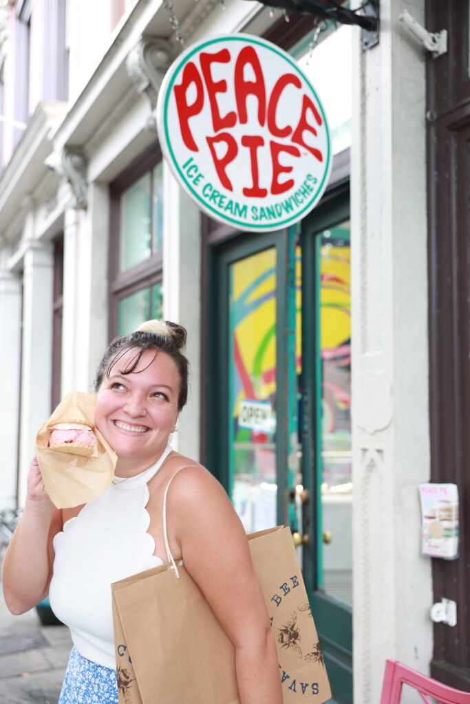 a photo of a a woman holding a dessert from Peace Pie,, one of the top places to eat in Charleston, SC