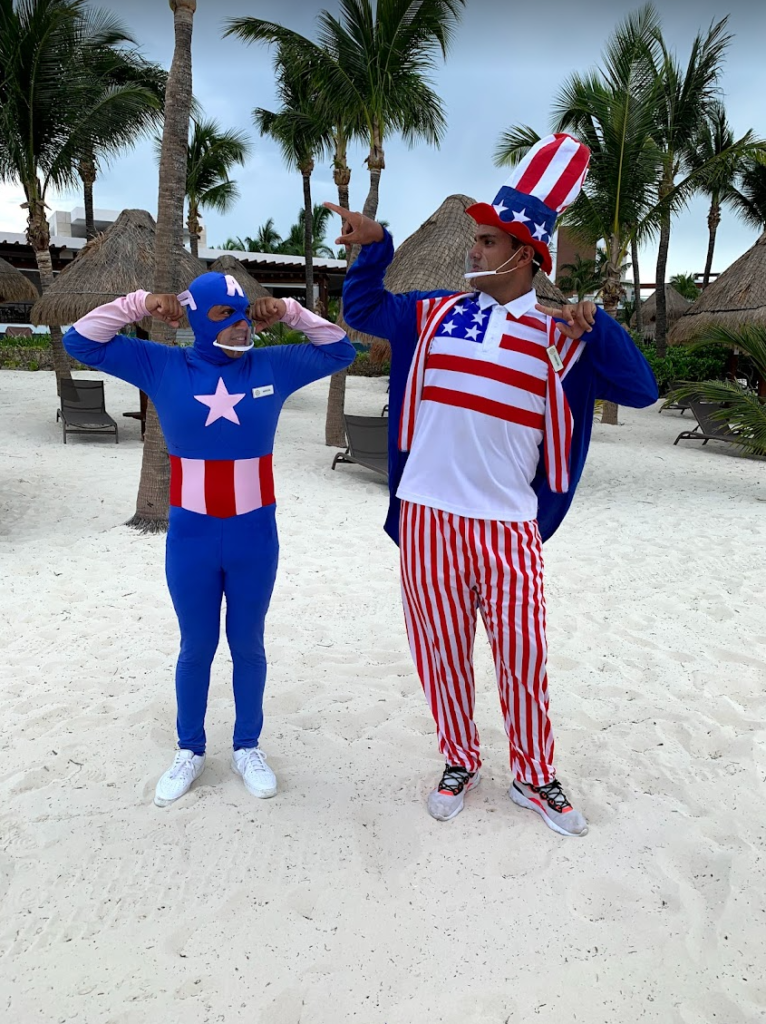 shot of staff at playa mujeres on the beach dressed up in July 4th costumes for the blog Are Excellence Collection Hotels the best?