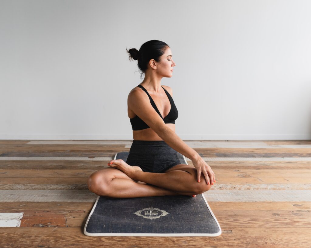 a photo of a woman stretching on a yoga mat, used in the blog on building a successful morning routine