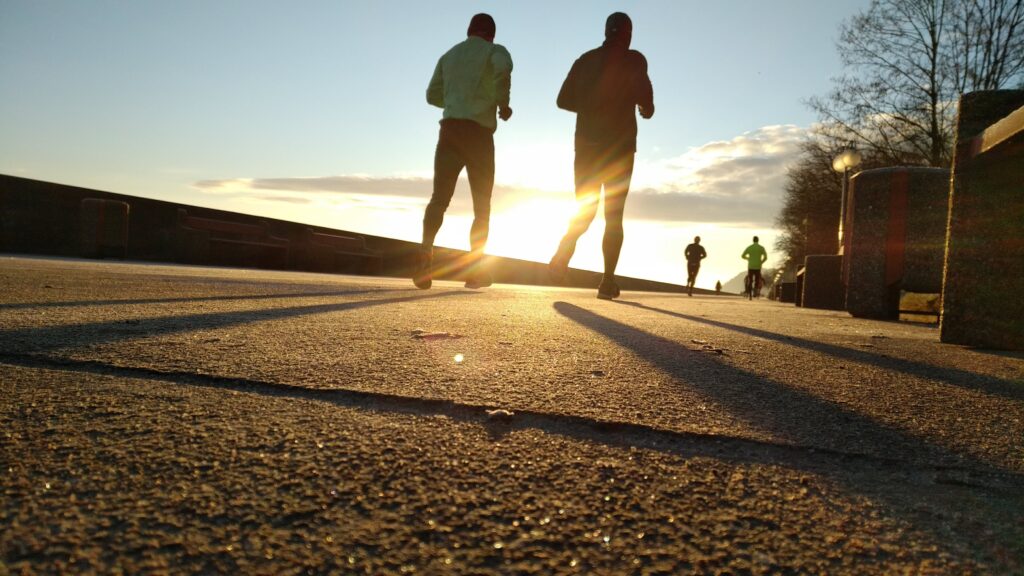 two people running on a road, a photo being used for a blog to stay fit this winter