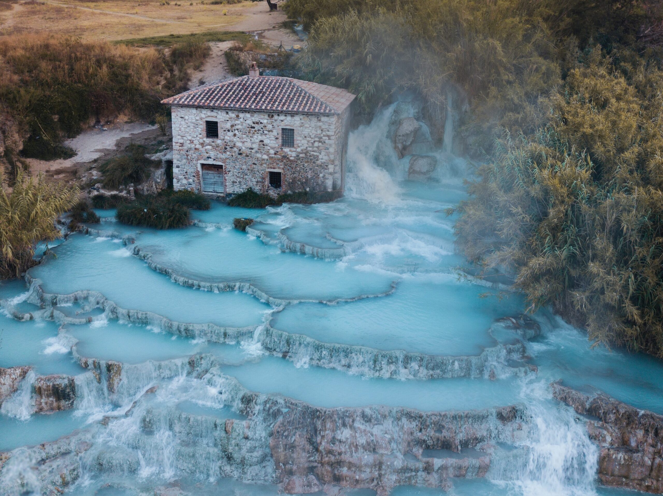 An image of the water and falls at Saturnia Springs in Italy, one of the Top 5 Hidden Gems in Italy