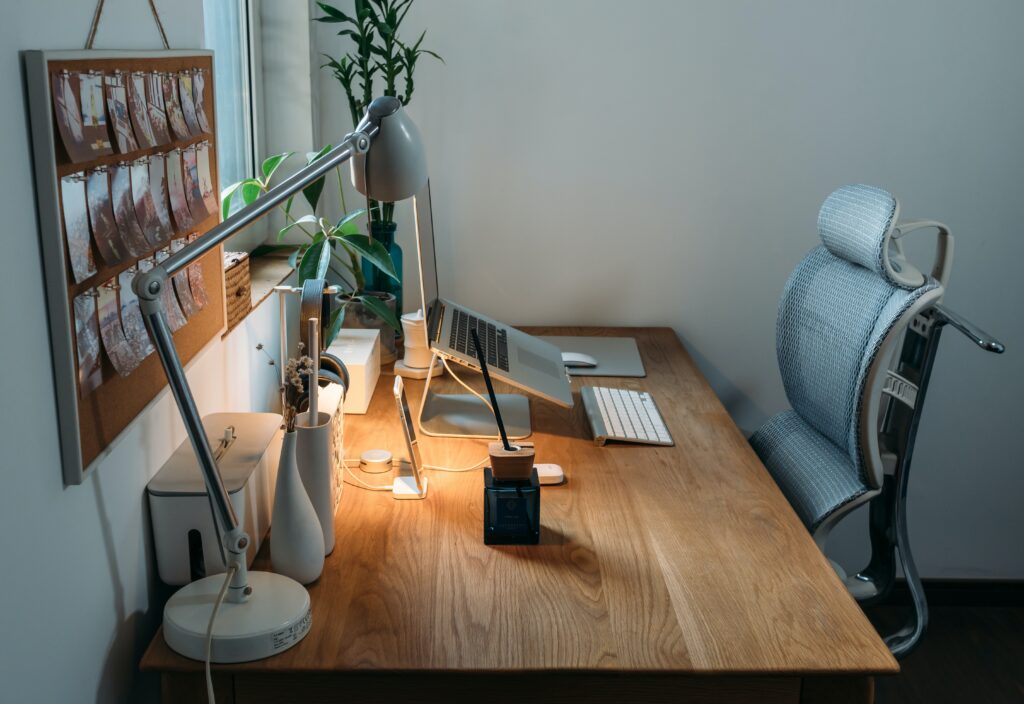 photo of a wooden desk with a laptop on it for the blog post on Home Office Design Trends
